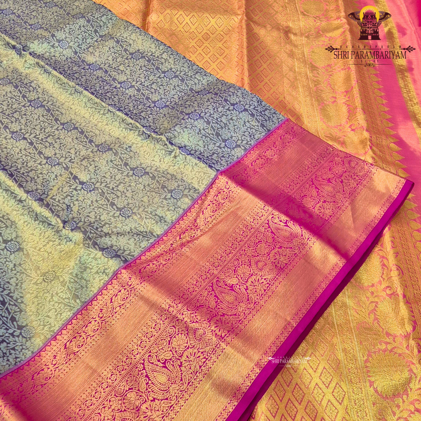 A sophisticated antique gold / champagne gold tissue body paired with a vibrant bright rani pink border Saree