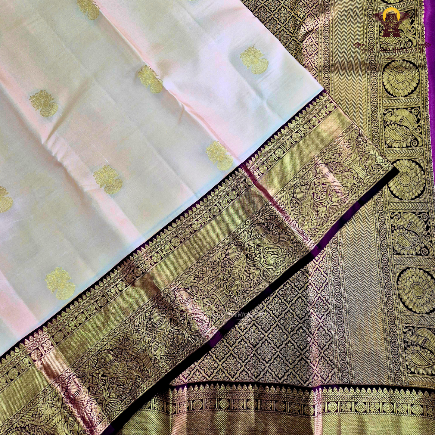 A elegant Cream Beige / Soft Sandal body with a rich Maroon Korvai Border Saree