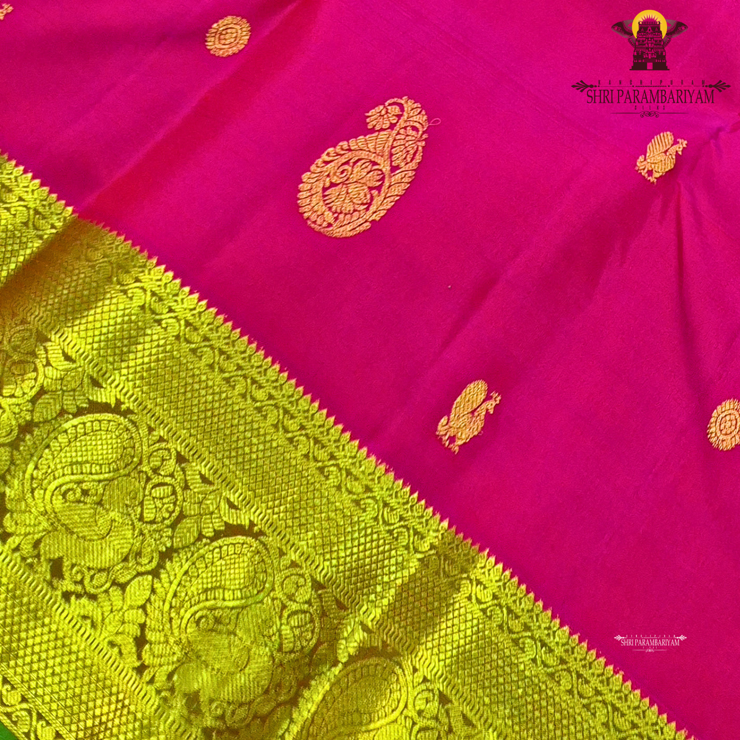 A elegant bright rani pink with rich gold zari border and a hint of green edging Saree
