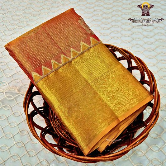 Rich golden tissue body with a rusty orange / copper-toned pallu Saree