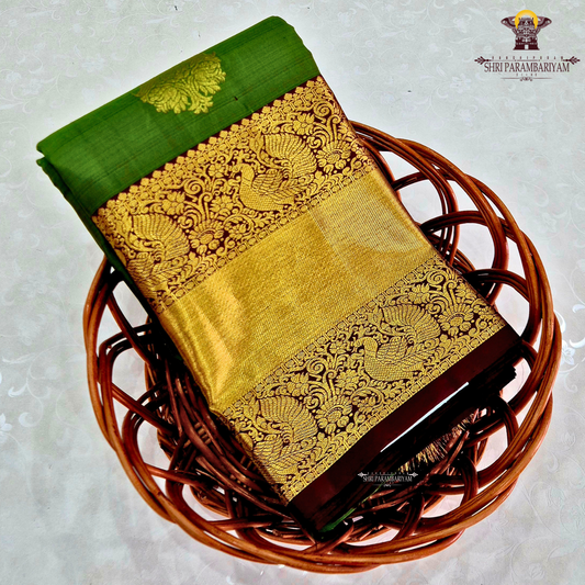 A parrot Green with Rich Gold Zari and Maroon Contrast Border Saree