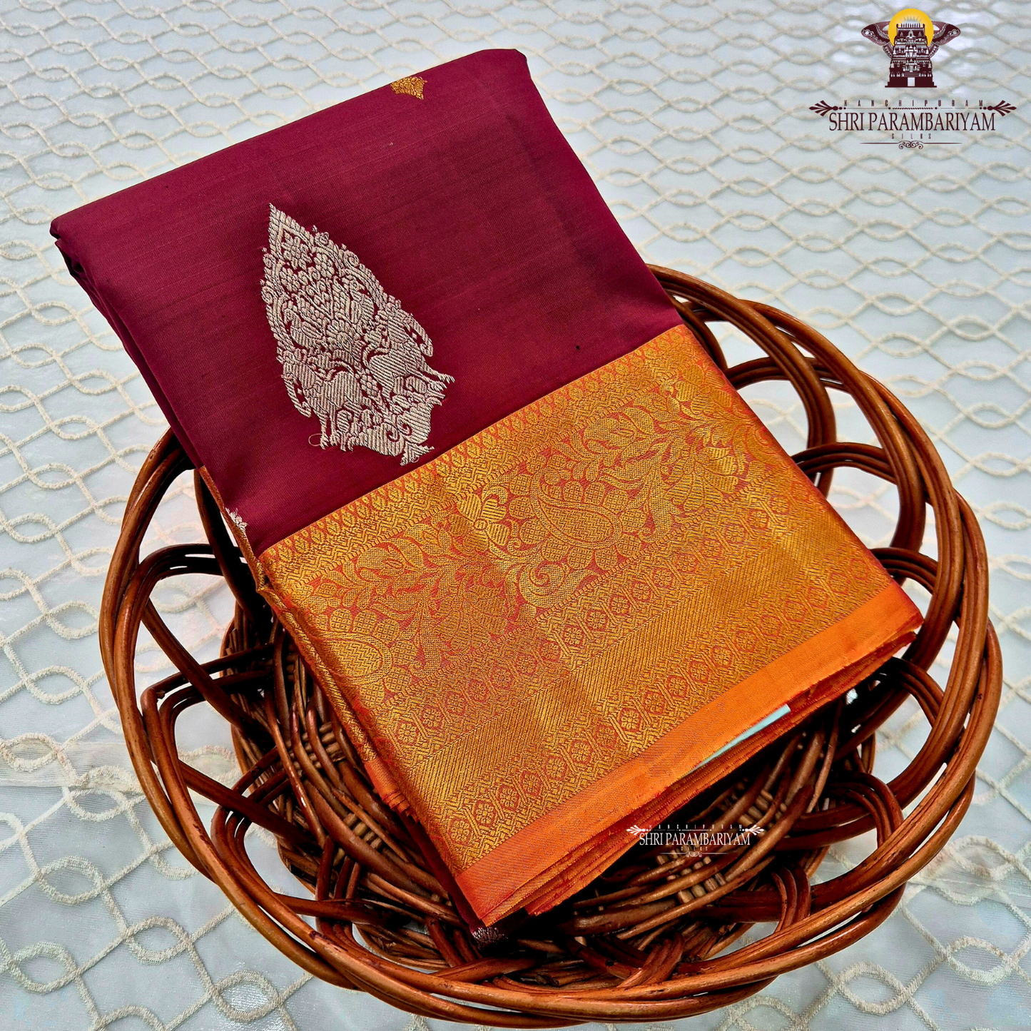 Deep maroon (wine red tone) with a rich contrast of golden zari and orange-toned border Saree