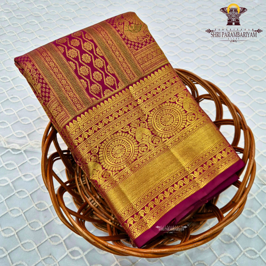 Deep magenta-red (rani red tone) with rich antique gold zari Saree