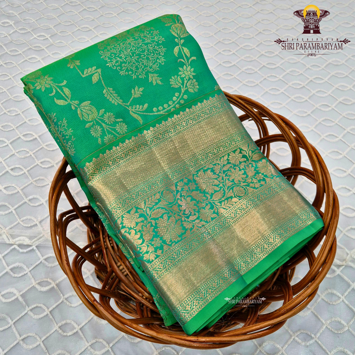 A rich and vibrant emerald green with elegant gold zari work Saree