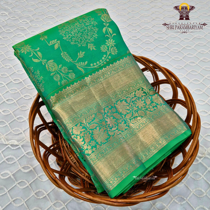 A rich and vibrant emerald green with elegant gold zari work Saree