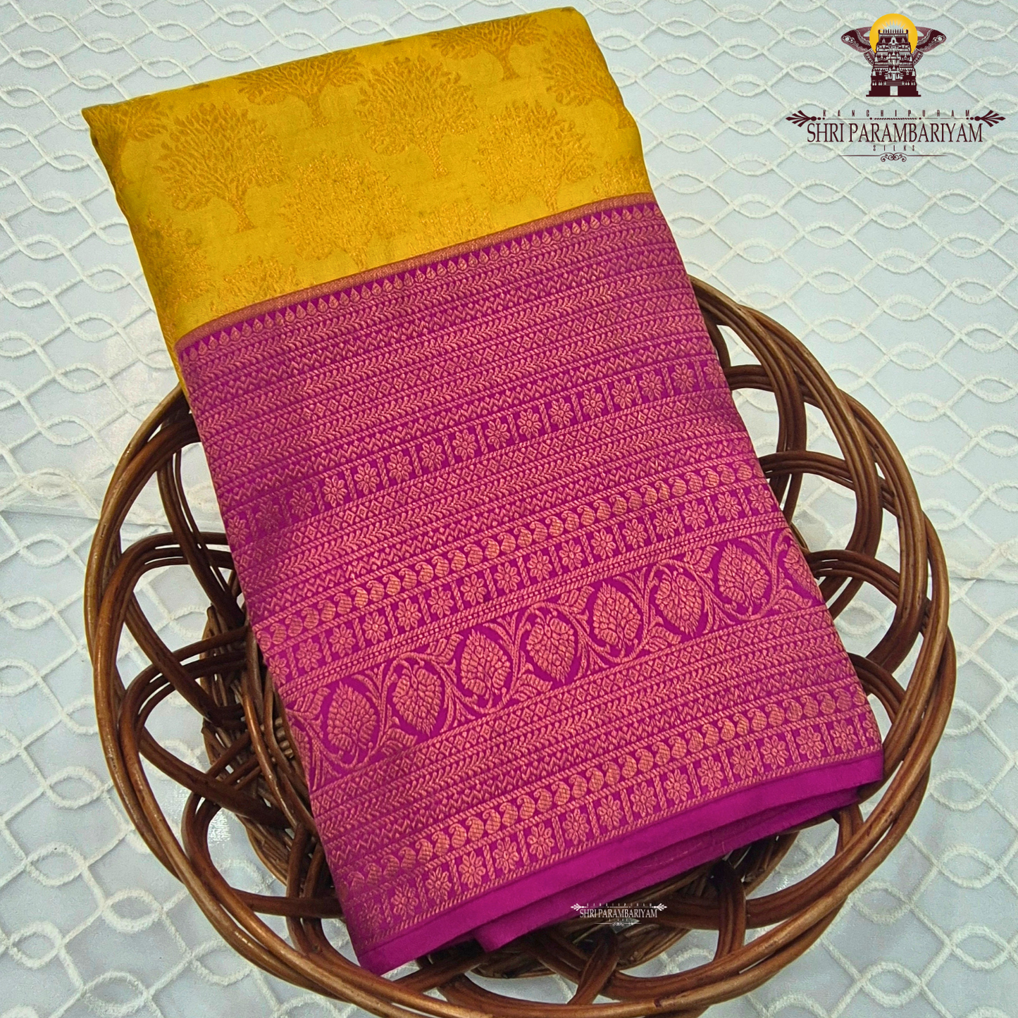 A vibrant mustard yellow (golden yellow) body paired with a rich rani pink (magenta) Korvai border Saree