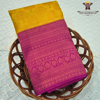 A vibrant mustard yellow (golden yellow) body paired with a rich rani pink (magenta) Korvai border Saree