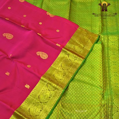 A elegant bright rani pink with rich gold zari border and a hint of green edging Saree