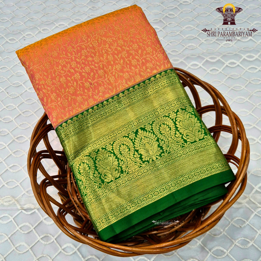 A beautiful peachy coral orange body with intricate gold zari Saree