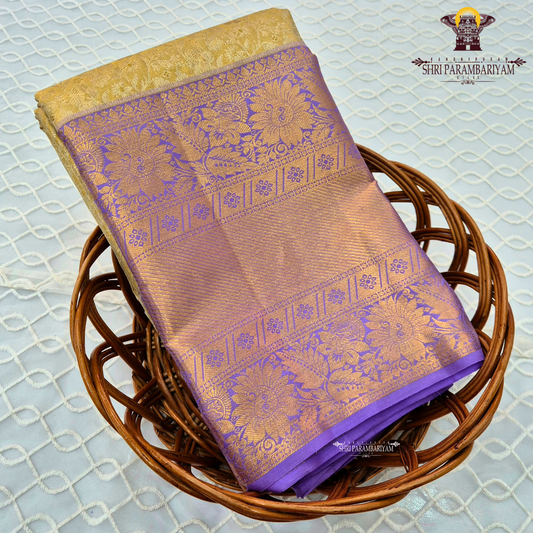 A rich combination of royal purple (violet) body with antique gold tissue Saree