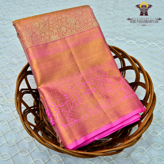 A beautiful peach gold body that shines with a luxurious tissue finish Saree