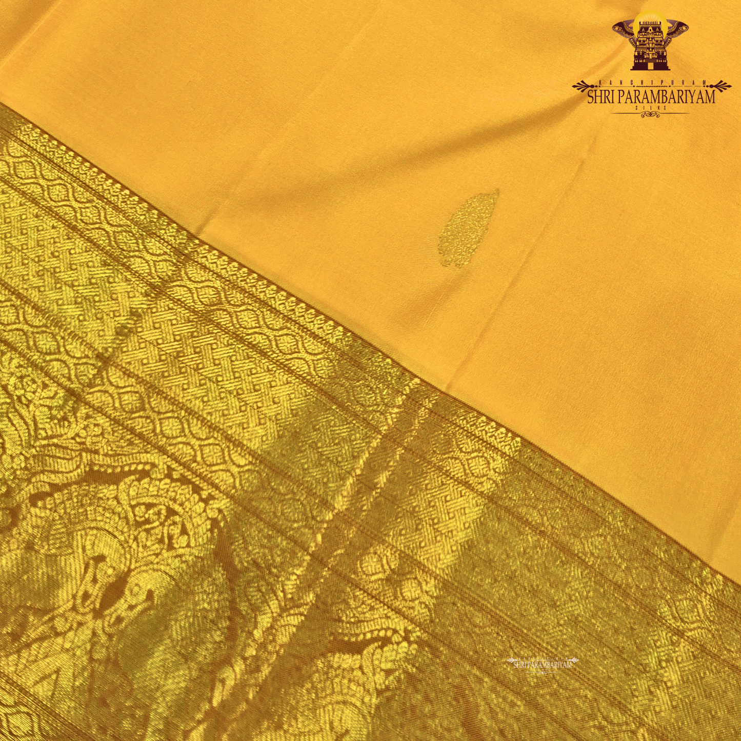 A bright turmeric yellow with rich gold zari border and a subtle maroon edging Saree