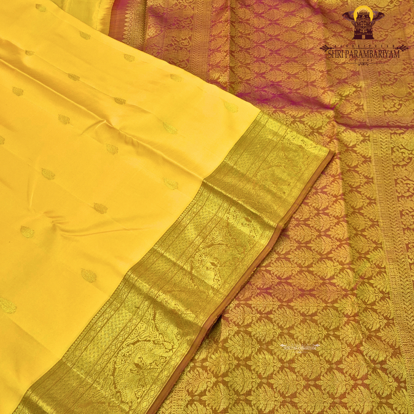 A bright turmeric yellow with rich gold zari border and a subtle maroon edging Saree