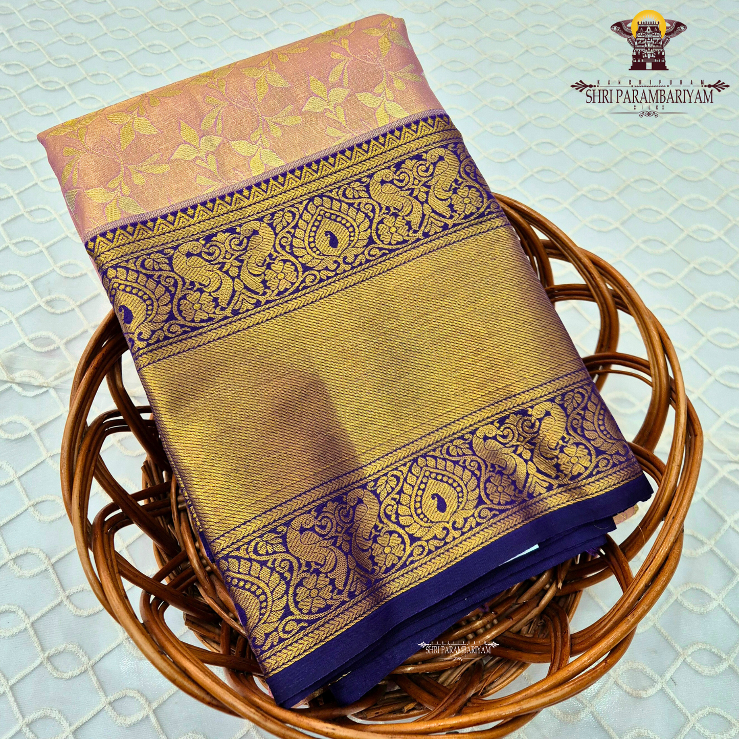 A soft and elegant peach / pastel rose gold body paired with a rich royal blue (navy blue) border Saree