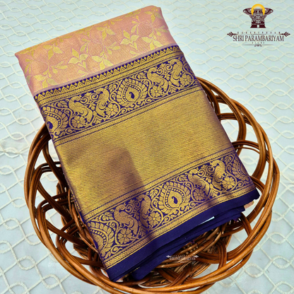 A soft and elegant peach / pastel rose gold body paired with a rich royal blue (navy blue) border Saree