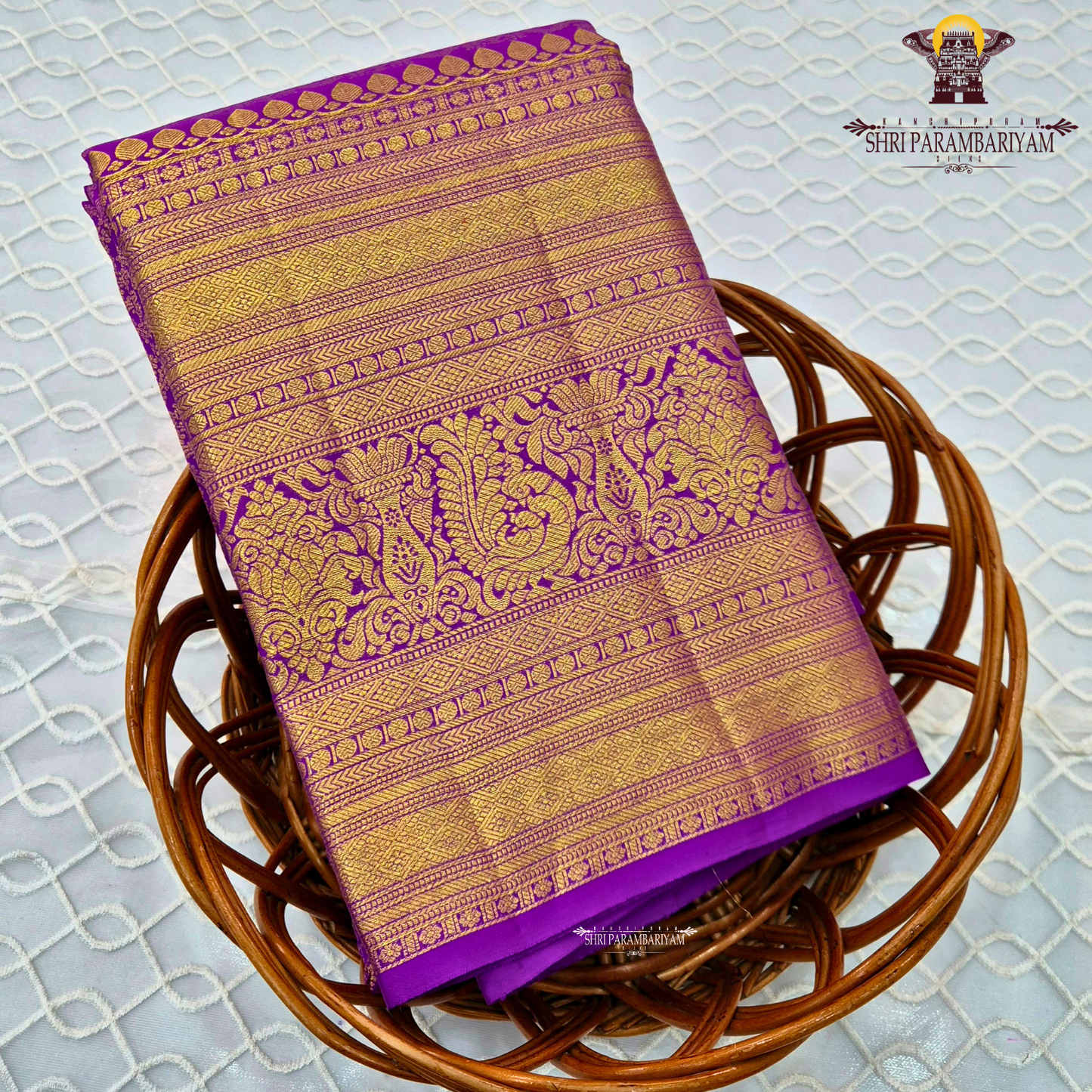 A vibrant purple and gold combination, with a rich golden zari Saree