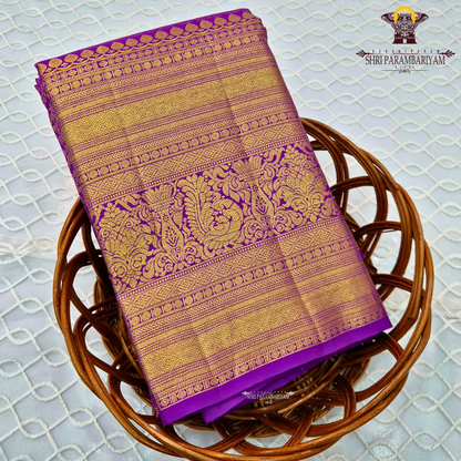 A vibrant purple and gold combination, with a rich golden zari Saree