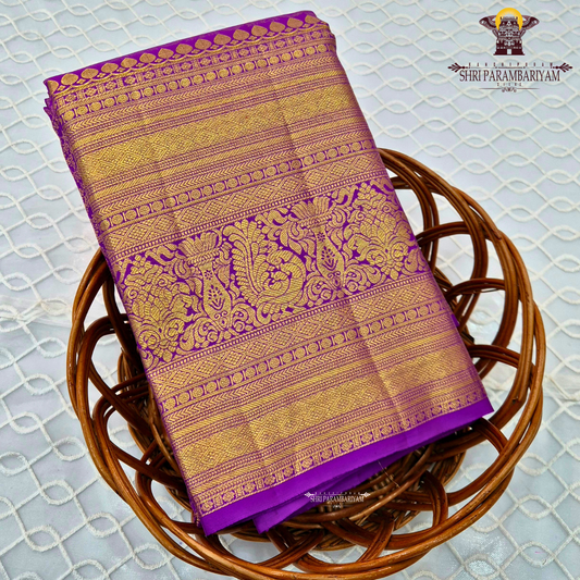 A vibrant purple and gold combination, with a rich golden zari Saree