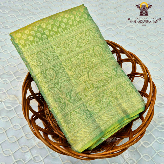 A vibrant parrot green body beautifully blended with a shimmering golden tissue finish Saree
