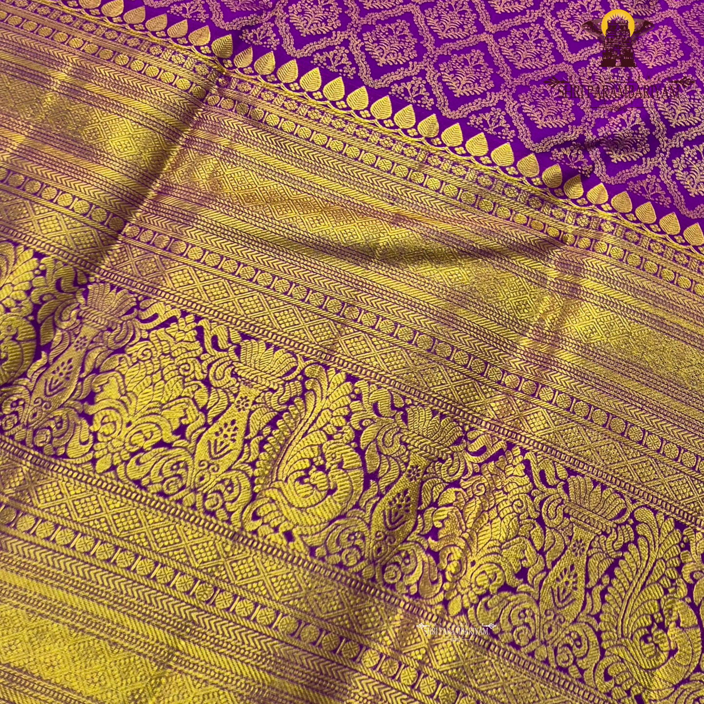 A vibrant purple and gold combination, with a rich golden zari Saree