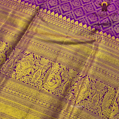 A vibrant purple and gold combination, with a rich golden zari Saree