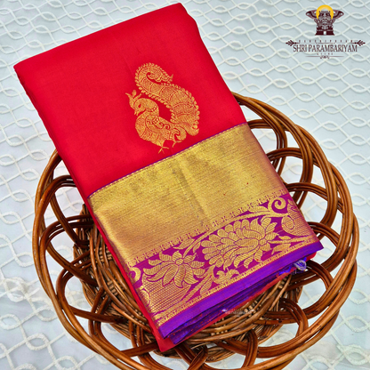 A vibrant red with rich gold zari border and contrast purple edging Saree