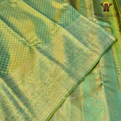 A vibrant parrot green body beautifully blended with a shimmering golden tissue finish Saree