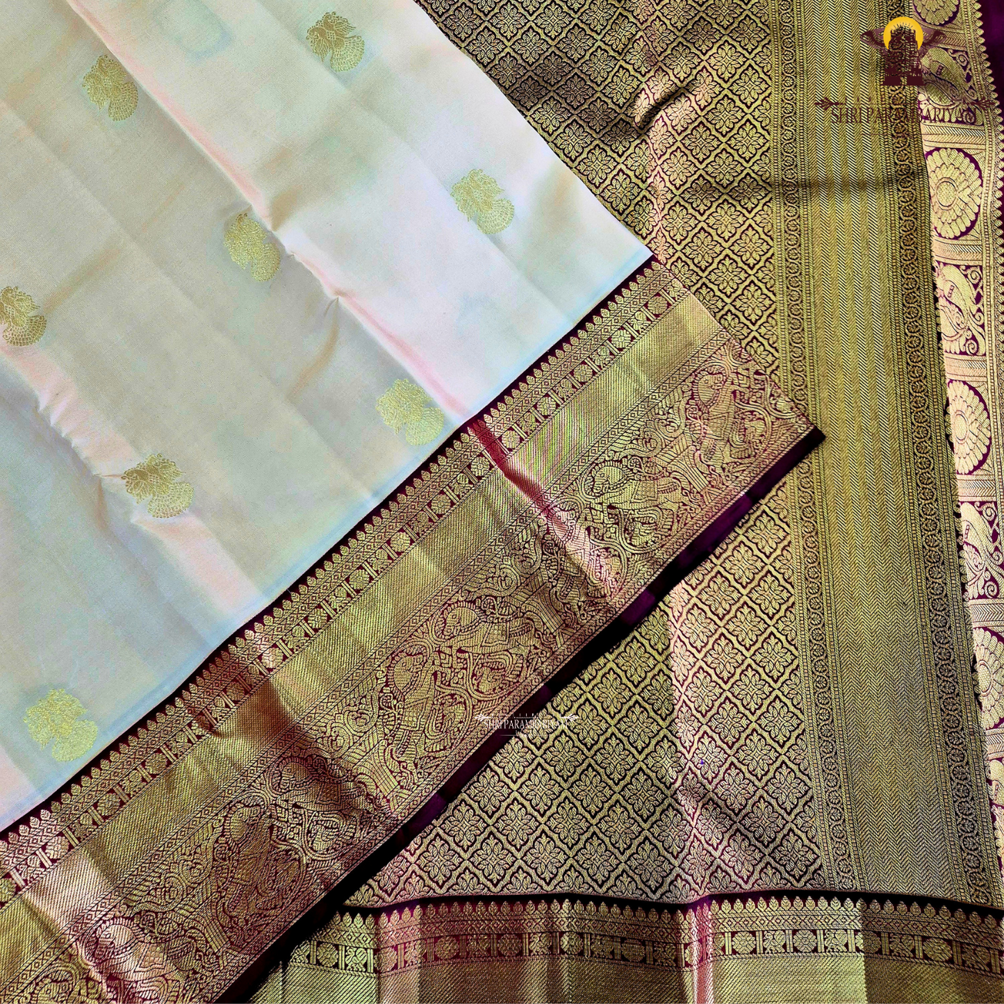 A classic Ivory Cream / Off-White body with a rich Maroon Korvai Border Saree