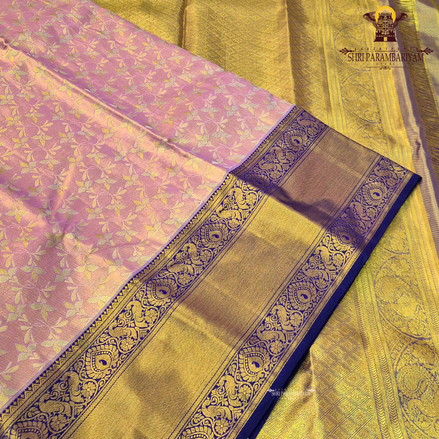 A soft and elegant peach / pastel rose gold body paired with a rich royal blue (navy blue) border Saree