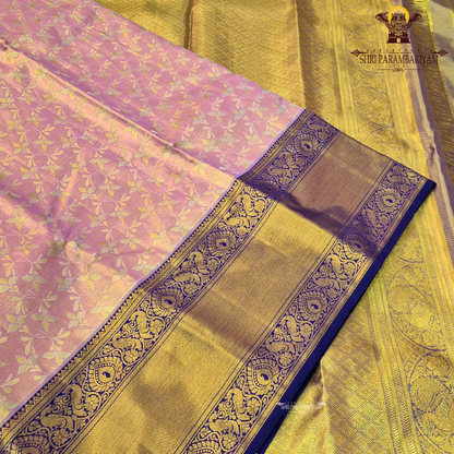 A soft and elegant peach / pastel rose gold body paired with a rich royal blue (navy blue) border Saree