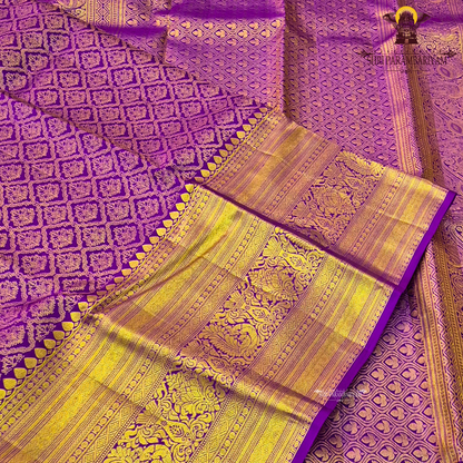 A vibrant purple and gold combination, with a rich golden zari Saree