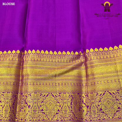 A vibrant purple and gold combination, with a rich golden zari Saree