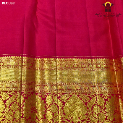 A soft pastel peach body paired with a rich deep red korvai border Saree