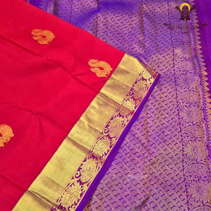 A vibrant red with rich gold zari border and contrast purple edging Saree