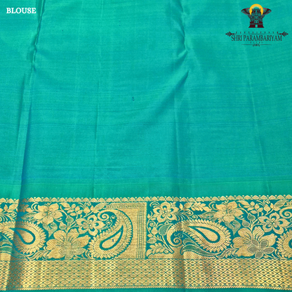 A rich deep magenta (pinkish-maroon) body paired with a peacock green border Saree