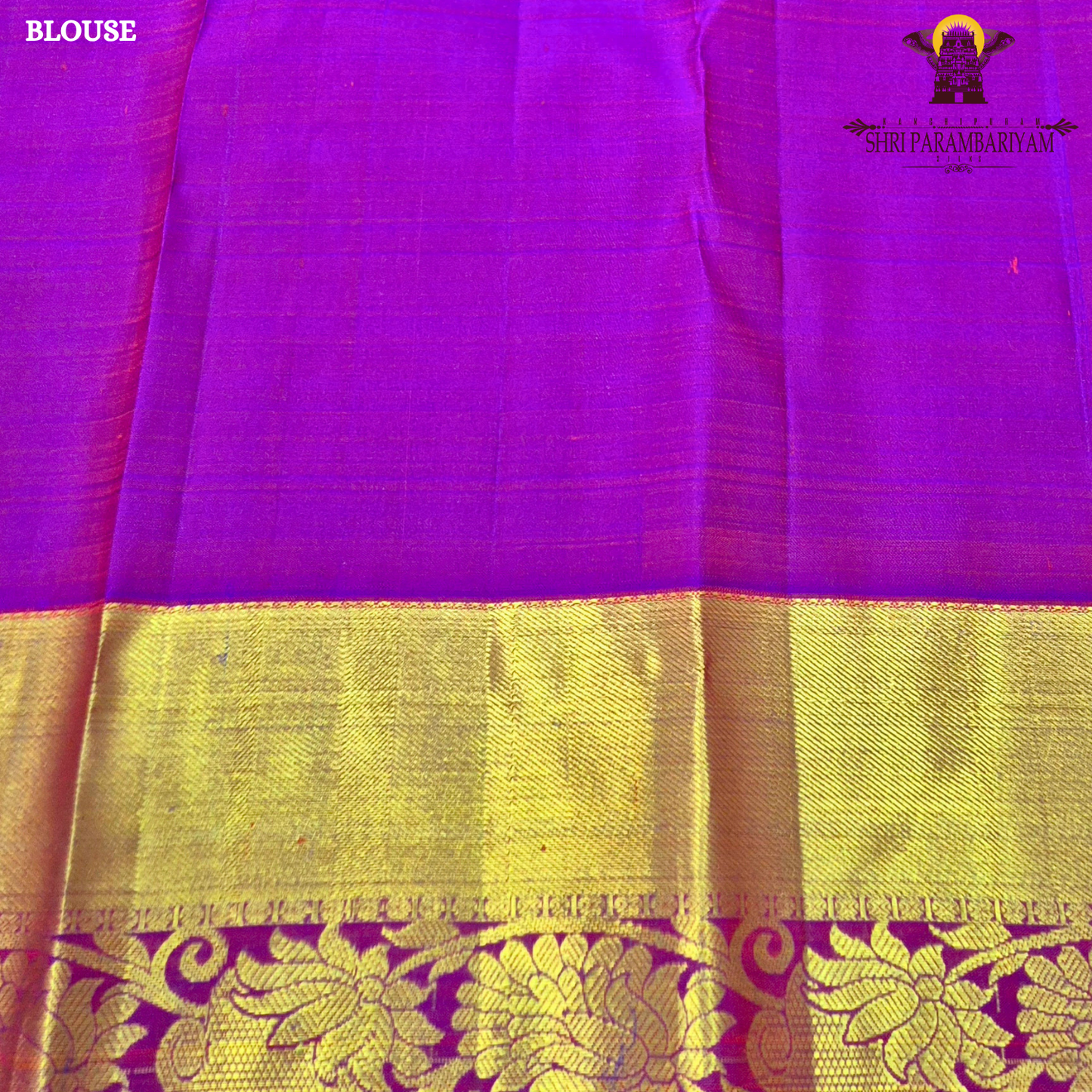 A vibrant red with rich gold zari border and contrast purple edging Saree