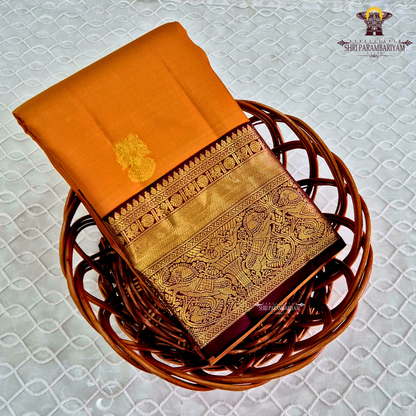 A radiant Mustard Orange / Marigold Orange body with a rich Maroon Korvai Border Saree