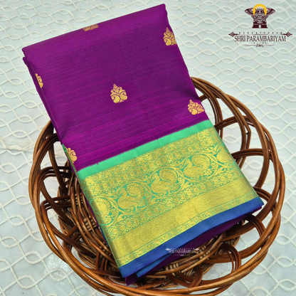 A rich royal purple body paired with a parrot green border highlighted Saree