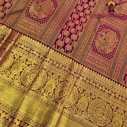 Deep magenta-red (rani red tone) with rich antique gold zari Saree