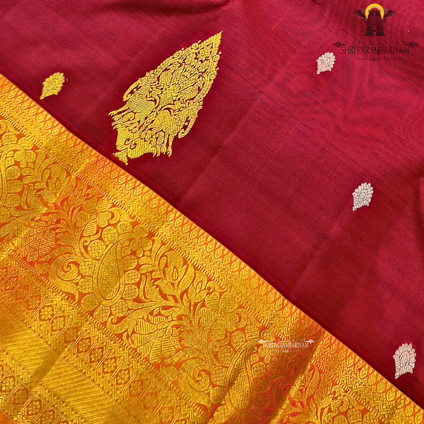 Deep maroon (wine red tone) with a rich contrast of golden zari and orange-toned border Saree