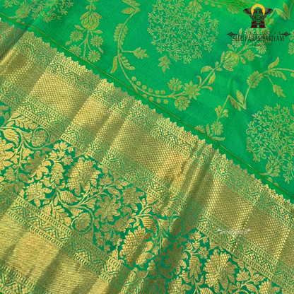 A rich and vibrant emerald green with elegant gold zari work Saree