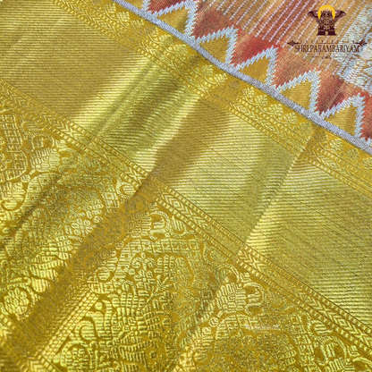 Rich golden tissue body with a rusty orange / copper-toned pallu Saree