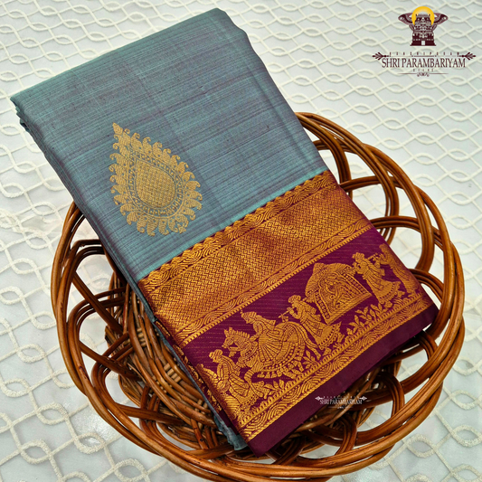 A elegant steel grey with rich gold zari border and contrast maroon/purple edging Saree