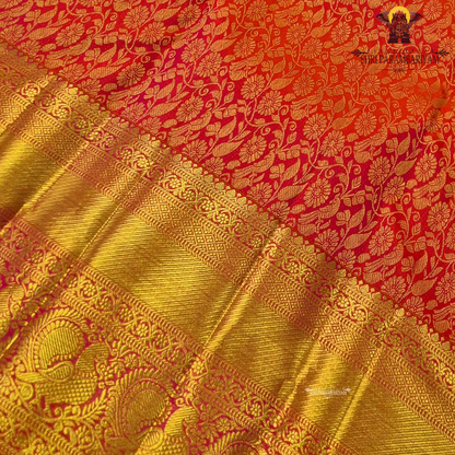 A vibrant reddish orange and pink combination with a radiant gold zari Saree