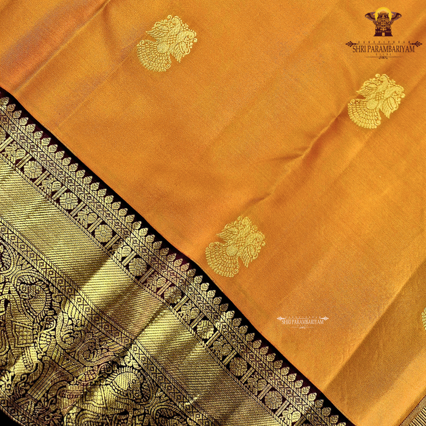 A radiant Mustard Orange / Marigold Orange body with a rich Maroon Korvai Border Saree
