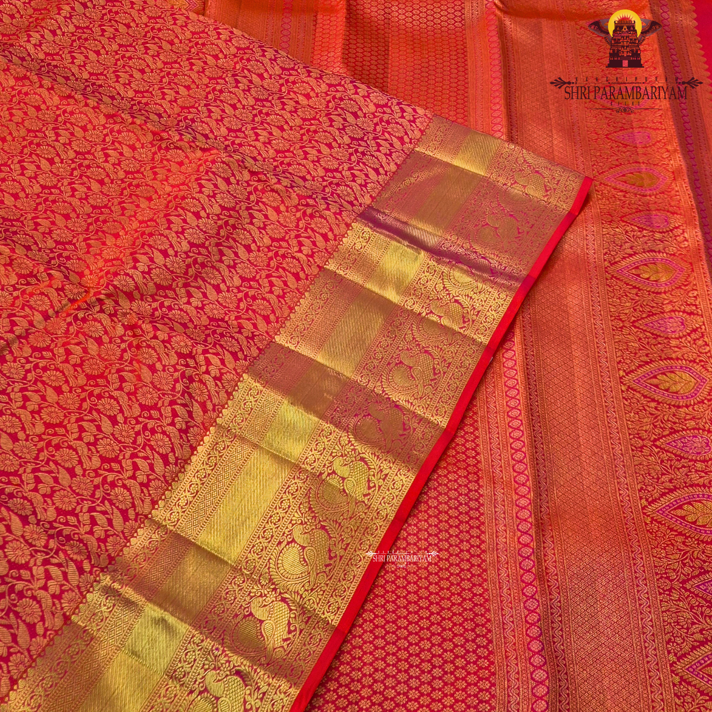 A vibrant reddish orange and pink combination with a radiant gold zari Saree