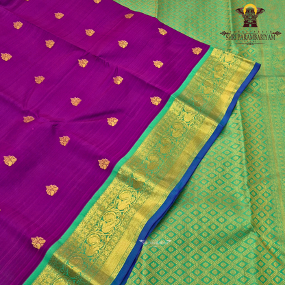 A rich royal purple body paired with a parrot green border highlighted Saree