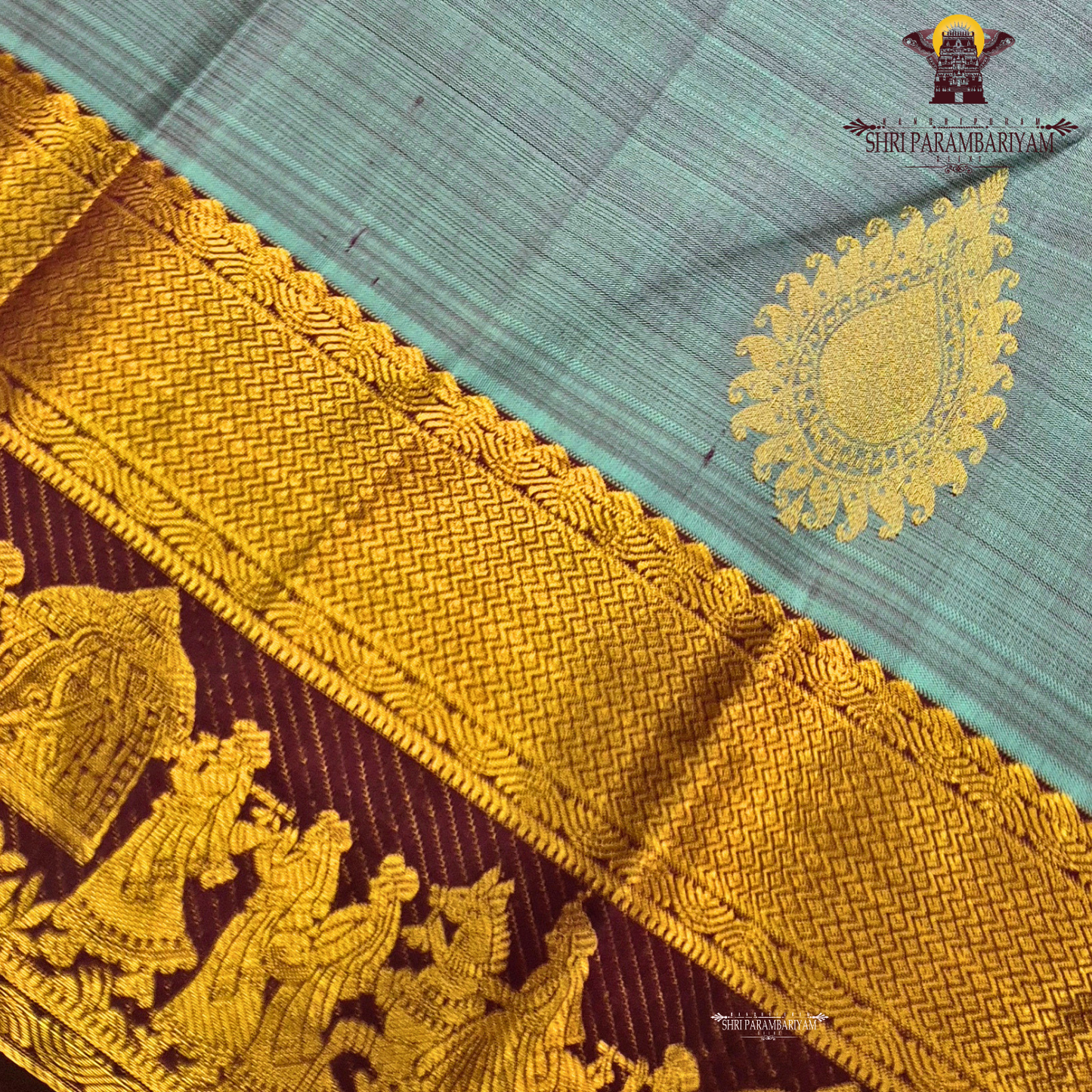 A elegant steel grey with rich gold zari border and contrast maroon/purple edging Saree