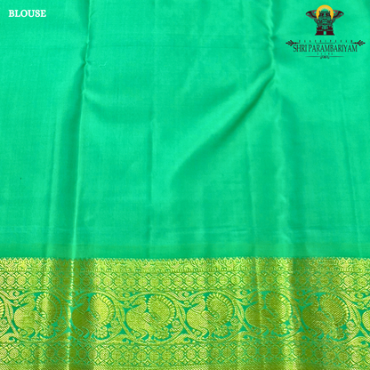 A rich royal purple body paired with a parrot green border highlighted Saree