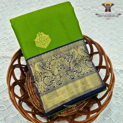 A bright parrot green body paired with a royal navy blue border richly woven Saree